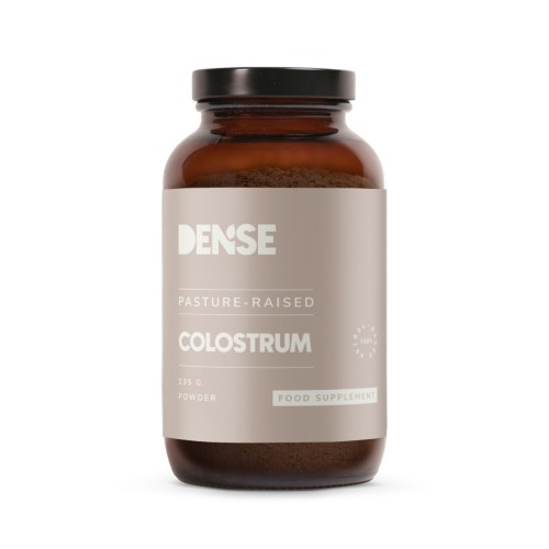 Kolostrum wołowe Dense 135 g – przód nowego opakowania: stojąca saszetka z zamknięciem strunowym, etykieta z logo DENSE i nazwą produktu, na białym tle.